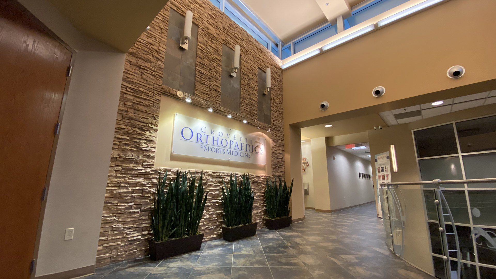 Lobby entrance at Crovetti Orthopaedics with stone wall and plants
