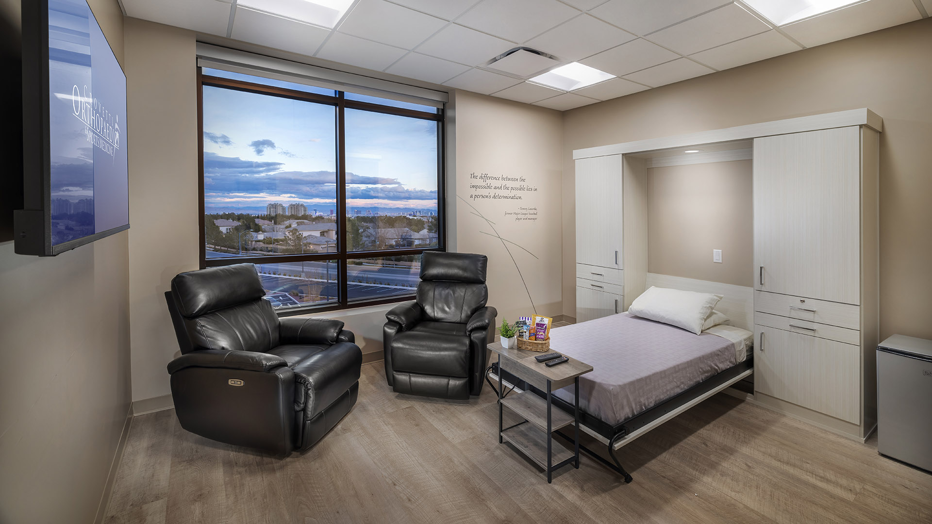 Private recovery suite with bed, chairs, and TV at Crovetti Orthopaedics